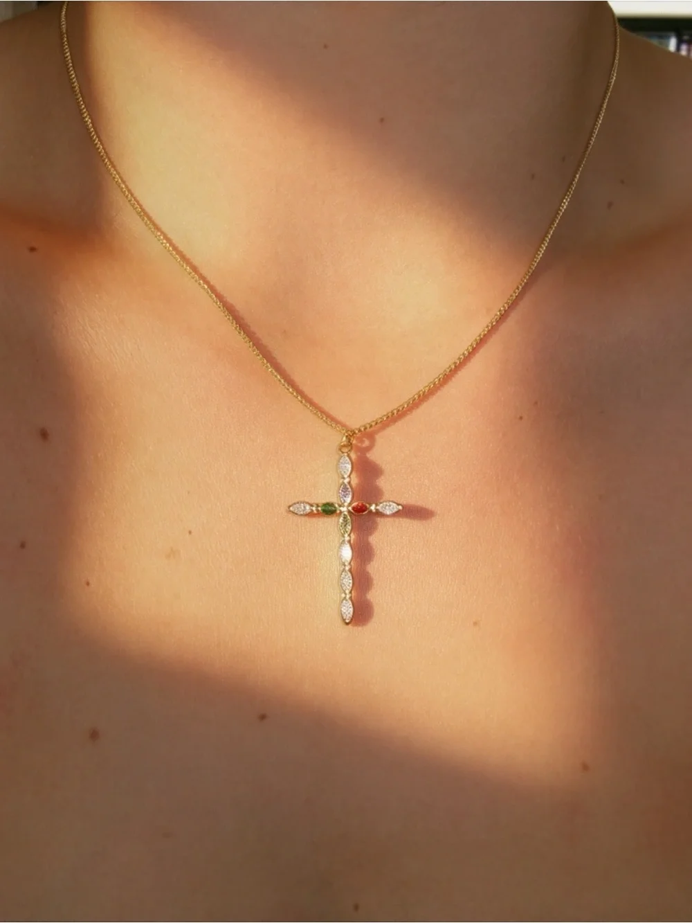Gold Cross Pendant Necklace with Green and Red Gem Accents